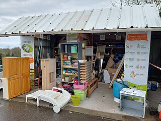 la photo de l'abricothèque représente un abri sous tôle avec des éléments de bricolage et de jardinage en bon état (placard de cuisine, transat, pot de fleur...) - Agrandir l'image, .JPG 4 Mo (fenêtre modale)